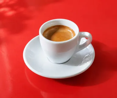 AI 生成示例：红色桌面上的白色咖啡杯